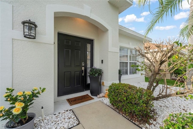 9795 Gladiolus Bulb Loop, Fort Myers, FL 33908 - doorway to property featuring stucco siding