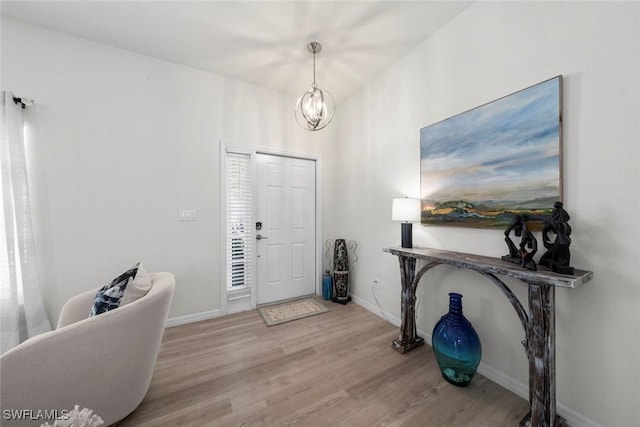 9795 Gladiolus Bulb Loop, Fort Myers, FL 33908 - foyer featuring wood finished floors and a chandelier