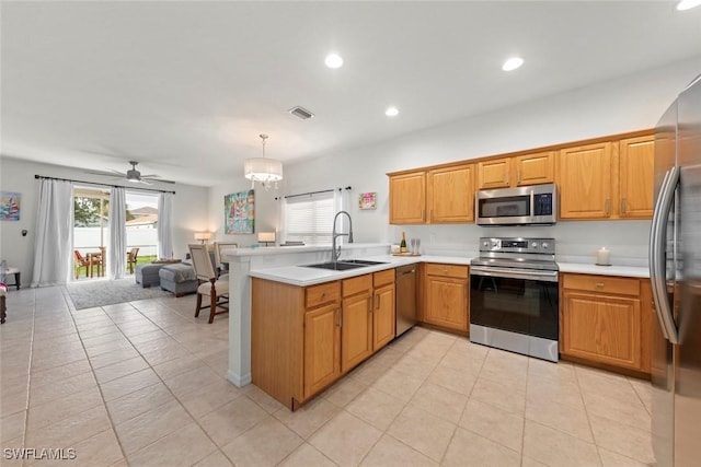 9795 Gladiolus Bulb Loop, Fort Myers, FL 33908 - kitchen featuring stainless steel appliances, a peninsula, open floor plan, light countertops, and recessed lighting
