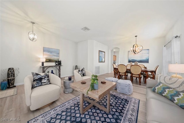9795 Gladiolus Bulb Loop, Fort Myers, FL 33908 - living area with a chandelier, wood finished floors, and arched walkways