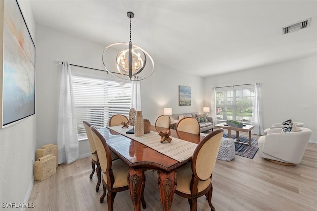 9795 Gladiolus Bulb Loop, Fort Myers, FL 33908 - dining area with light wood finished floors and a chandelier