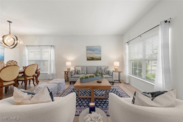 9795 Gladiolus Bulb Loop, Fort Myers, FL 33908 - living room with a chandelier and light wood-style flooring