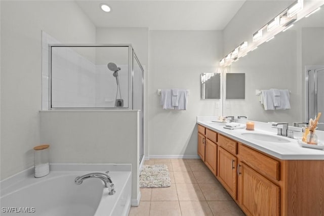 9795 Gladiolus Bulb Loop, Fort Myers, FL 33908 - bathroom featuring a shower stall, a bath, double vanity, and tile patterned floors