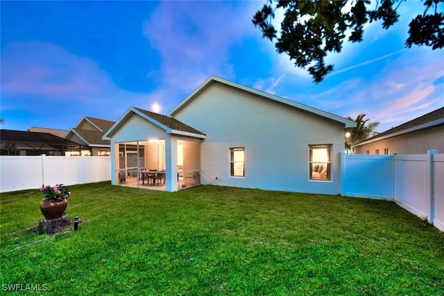 9795 Gladiolus Bulb Loop, Fort Myers, FL 33908 - rear view of house featuring stucco siding, a fenced backyard, a sunroom, and a patio