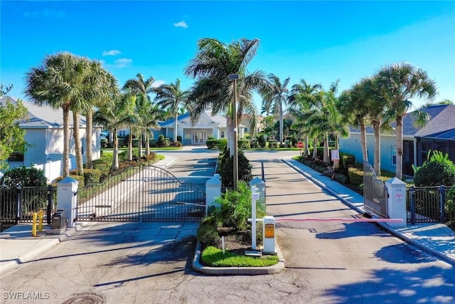 9795 Gladiolus Bulb Loop, Fort Myers, FL 33908 - view of asphalt road featuring curbs, a gate, and a gated entry