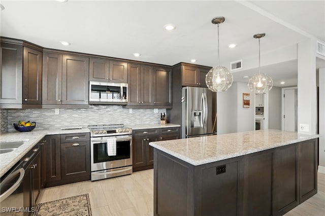 7148 Estero Blvd Unit 922, Fort Myers Beach, FL 33931 - kitchen with stainless steel appliances, dark brown cabinets, tasteful backsplash, and recessed lighting