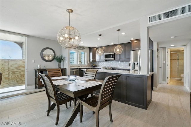 7148 Estero Blvd Unit 922, Fort Myers Beach, FL 33931 - dining room featuring a chandelier, recessed lighting, and light wood-style floors