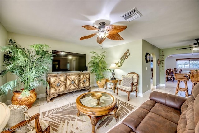225 SW 43rd Ln, Cape Coral, FL 33914 - living room with a ceiling fan, light tile patterned floors, and arched walkways