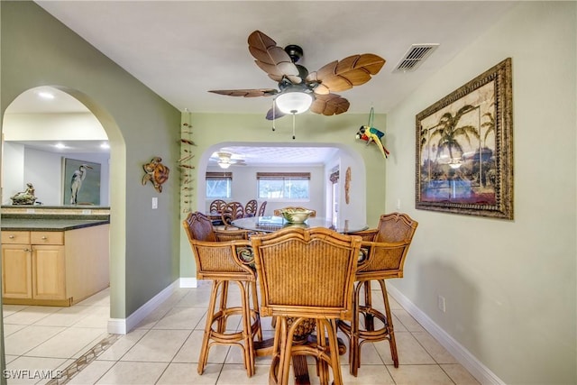 225 SW 43rd Ln, Cape Coral, FL 33914 - dining space featuring arched walkways, ceiling fan, and light tile patterned floors