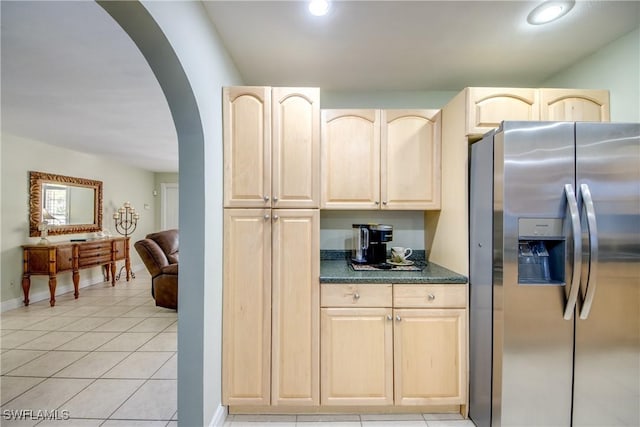 225 SW 43rd Ln, Cape Coral, FL 33914 - kitchen with stainless steel refrigerator with ice dispenser, arched walkways, light brown cabinets, dark countertops, and light tile patterned floors
