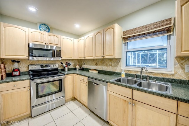 225 SW 43rd Ln, Cape Coral, FL 33914 - kitchen with stainless steel appliances, light brown cabinetry, dark countertops, and recessed lighting