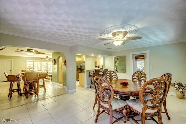 225 SW 43rd Ln, Cape Coral, FL 33914 - dining space with ceiling fan, arched walkways, plenty of natural light, and a textured ceiling