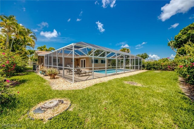 225 SW 43rd Ln, Cape Coral, FL 33914 - rear view of property with a patio, a lawn, a lanai, and an outdoor pool