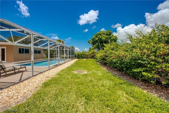 225 SW 43rd Ln, Cape Coral, FL 33914 - view of grassy yard with a patio, an outdoor pool, and a lanai