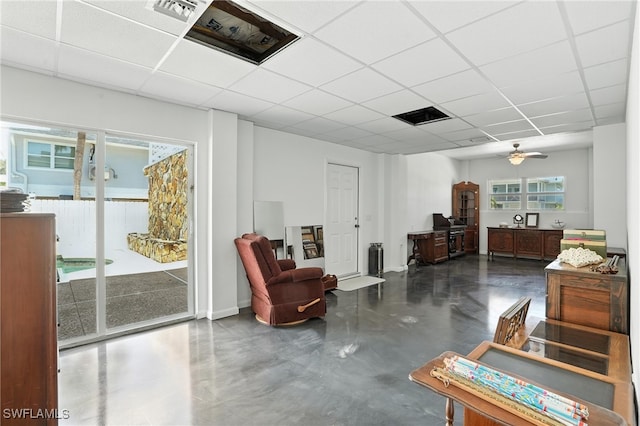 131 Bay Mar Dr, Fort Myers Beach, FL 33931 - living room featuring a paneled ceiling, finished concrete flooring, and a ceiling fan