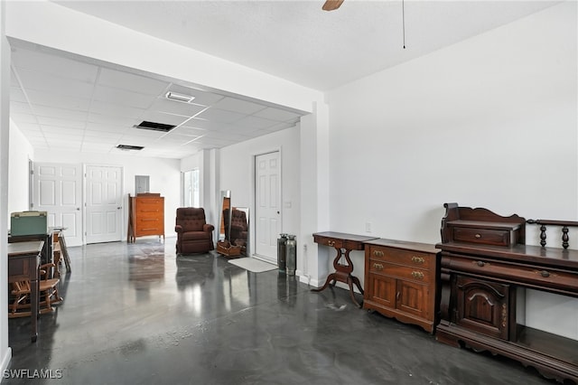 131 Bay Mar Dr, Fort Myers Beach, FL 33931 - misc room with finished concrete floors, a paneled ceiling, and a ceiling fan