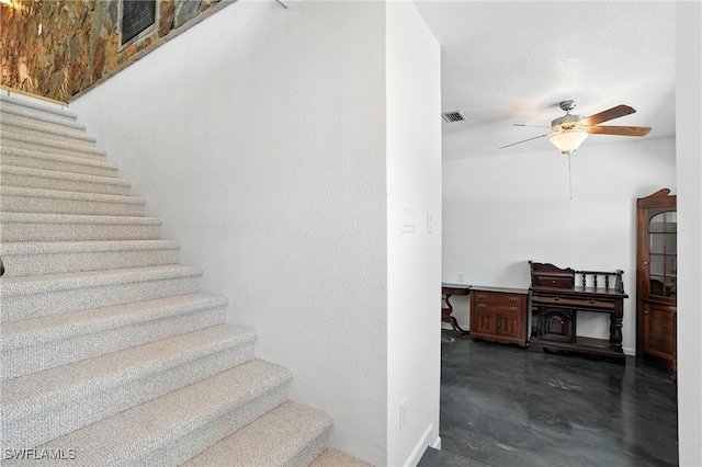 131 Bay Mar Dr, Fort Myers Beach, FL 33931 - stairs featuring a ceiling fan and concrete flooring