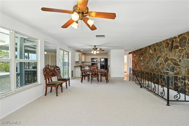 131 Bay Mar Dr, Fort Myers Beach, FL 33931 - dining space with light carpet and a ceiling fan