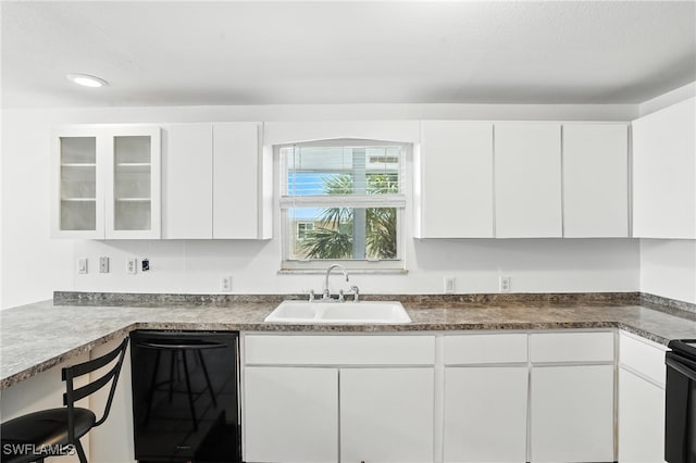 131 Bay Mar Dr, Fort Myers Beach, FL 33931 - kitchen with dishwasher, white cabinetry, glass insert cabinets, dark countertops, and recessed lighting