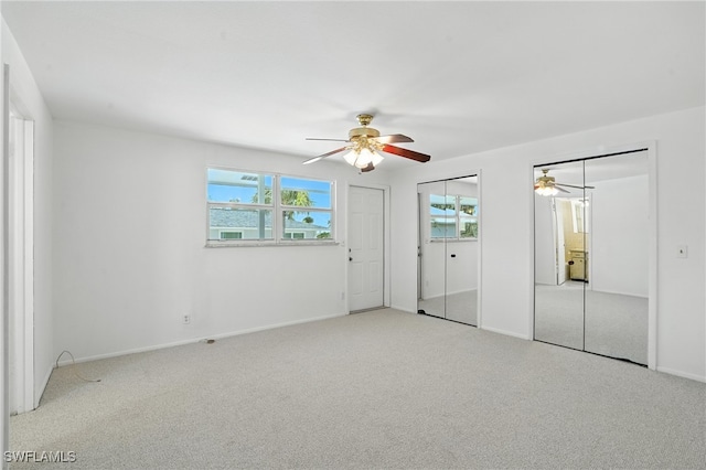 131 Bay Mar Dr, Fort Myers Beach, FL 33931 - unfurnished bedroom featuring carpet flooring, multiple windows, and a ceiling fan