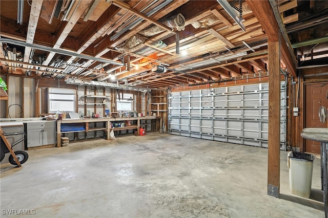 131 Bay Mar Dr, Fort Myers Beach, FL 33931 - garage featuring a garage door opener and a workshop area