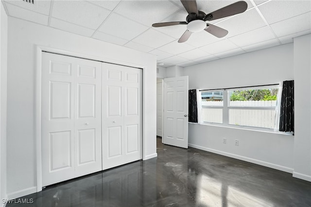 131 Bay Mar Dr, Fort Myers Beach, FL 33931 - unfurnished bedroom with a drop ceiling, finished concrete floors, a closet, and ceiling fan