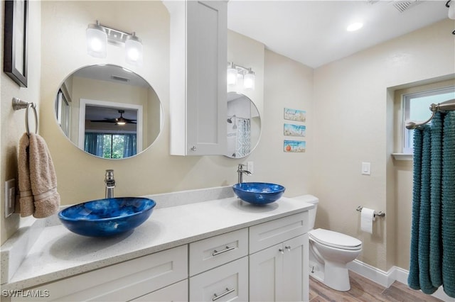15878 Gleneagle Ct, Fort Myers, FL 33908 - bathroom with ceiling fan, double vanity, and wood finished floors