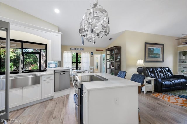 15878 Gleneagle Ct, Fort Myers, FL 33908 - kitchen featuring appliances with stainless steel finishes, open floor plan, light countertops, white cabinets, and recessed lighting