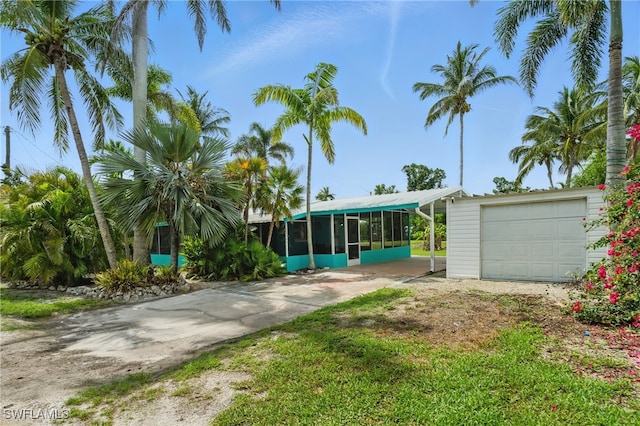 7434 Cares Away Park Cir, Bokeelia, FL 33922 - view of front of property with a sunroom, driveway, and an outdoor structure
