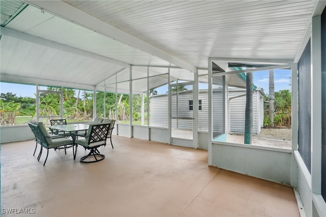 7434 Cares Away Park Cir, Bokeelia, FL 33922 - sunroom with outdoor dining area and vaulted ceiling