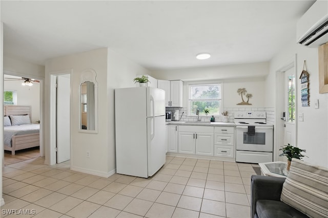 7434 Cares Away Park Cir, Bokeelia, FL 33922 - kitchen featuring white appliances, light tile patterned flooring, a wall unit AC, light countertops, and tasteful backsplash