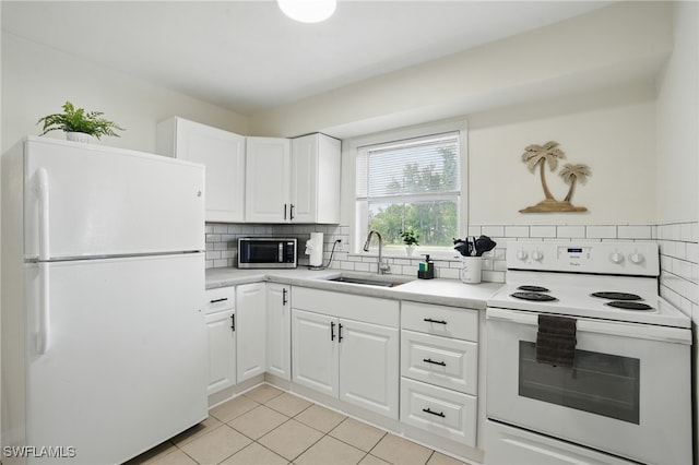 7434 Cares Away Park Cir, Bokeelia, FL 33922 - kitchen with white appliances, tasteful backsplash, light tile patterned flooring, and light countertops