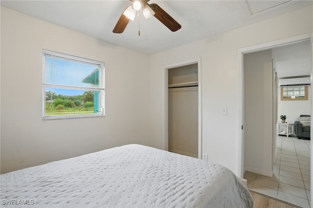 7434 Cares Away Park Cir, Bokeelia, FL 33922 - bedroom with light tile patterned floors, a ceiling fan, and a closet