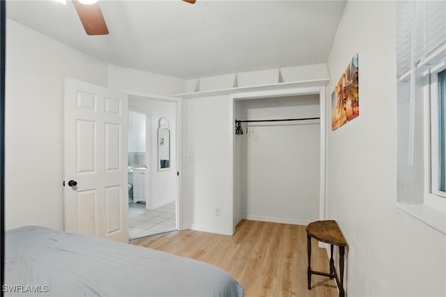 7434 Cares Away Park Cir, Bokeelia, FL 33922 - bedroom featuring light wood-style floors, a closet, and a ceiling fan
