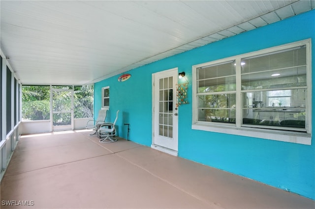 7434 Cares Away Park Cir, Bokeelia, FL 33922 - unfurnished sunroom featuring finished concrete floors