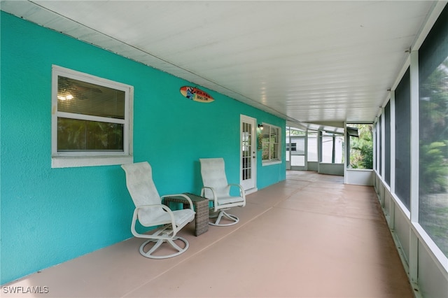 7434 Cares Away Park Cir, Bokeelia, FL 33922 - unfurnished sunroom with concrete flooring