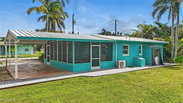 7434 Cares Away Park Cir, Bokeelia, FL 33922 - back of property featuring a sunroom, a yard, and a metal roof