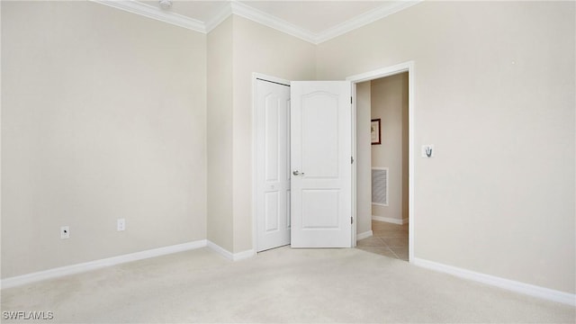 3668 Treasure Cove Ct, Naples, FL 34114 - unfurnished bedroom featuring light colored carpet, crown molding, and a closet