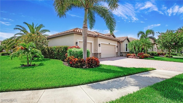 3668 Treasure Cove Ct, Naples, FL 34114 - mediterranean / spanish house with a garage, stone siding, stucco siding, a front yard, and driveway