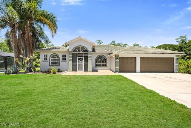 2391 35th Ave NE, Naples, FL 34120 - mediterranean / spanish-style home featuring an attached garage, concrete driveway, stucco siding, and a front yard