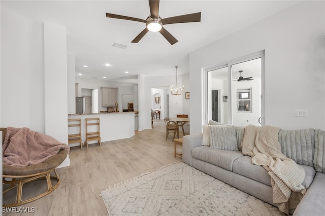 2391 35th Ave NE, Naples, FL 34120 - living area featuring light wood-style floors, a ceiling fan, a chandelier, and recessed lighting
