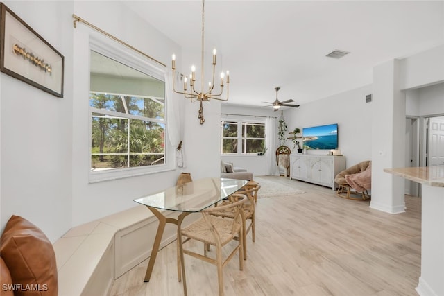 2391 35th Ave NE, Naples, FL 34120 - dining space featuring light wood finished floors, a chandelier, and ceiling fan