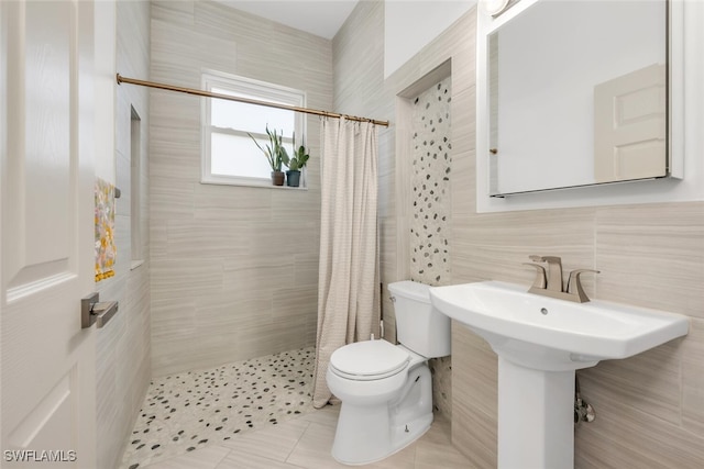 2391 35th Ave NE, Naples, FL 34120 - bathroom with tile walls, tiled shower, and tile patterned floors