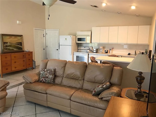 796 108th Ave N, Naples, FL 34108 - living area with light tile patterned floors, high vaulted ceiling, and a ceiling fan