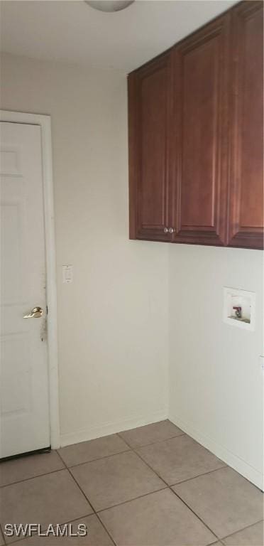 15539 Horseshoe Ln, Fort Myers, FL 33905 - laundry area featuring cabinet space, washer hookup, and light tile patterned floors