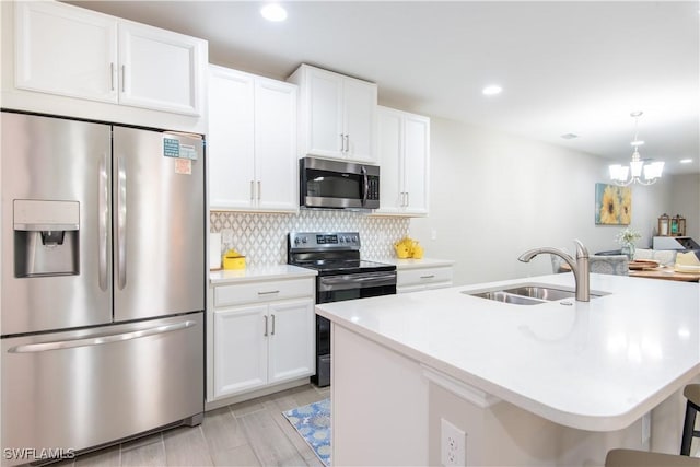 14727 Edgewater Cir, Naples, FL 34114 - kitchen with appliances with stainless steel finishes, tasteful backsplash, light countertops, white cabinetry, and recessed lighting