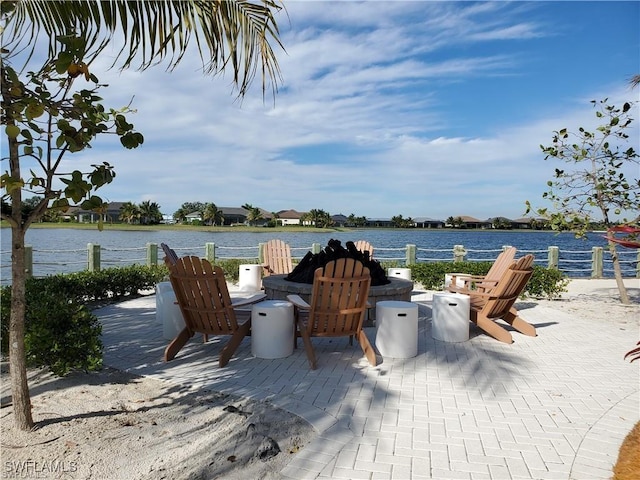 14727 Edgewater Cir, Naples, FL 34114 - view of patio with a fire pit and a water view