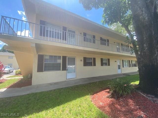 3325 Airport Pulling Rd N Unit F1, Naples, FL 34105 - rear view of house with stucco siding