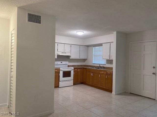 3325 Airport Pulling Rd N Unit F1, Naples, FL 34105 - kitchen featuring white range with electric stovetop, under cabinet range hood, a textured ceiling, and light tile patterned floors