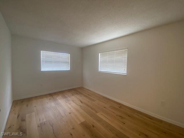 3325 Airport Pulling Rd N Unit F1, Naples, FL 34105 - empty room with wood finished floors and baseboards